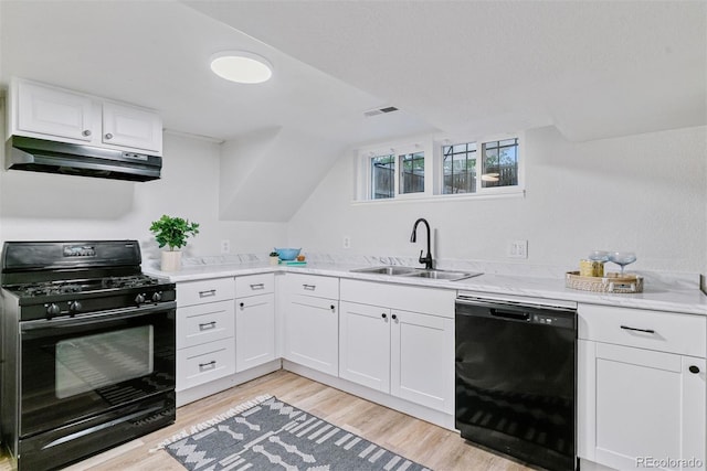 4003 Federal Blvd, Denver, CO 80211 - kitchen with black appliances, under cabinet range hood, a sink, light wood finished floors, and white cabinets