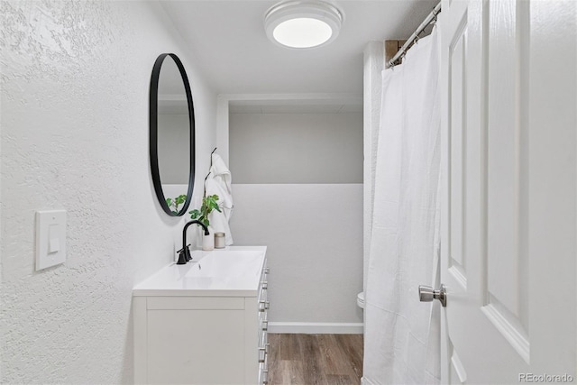4003 Federal Blvd, Denver, CO 80211 - bathroom featuring wood finished floors, vanity, a textured wall, toilet, and baseboards