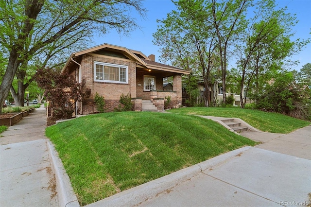4003 Federal Blvd, Denver, CO 80211 - view of front of home featuring brick siding, a front yard, and covered porch