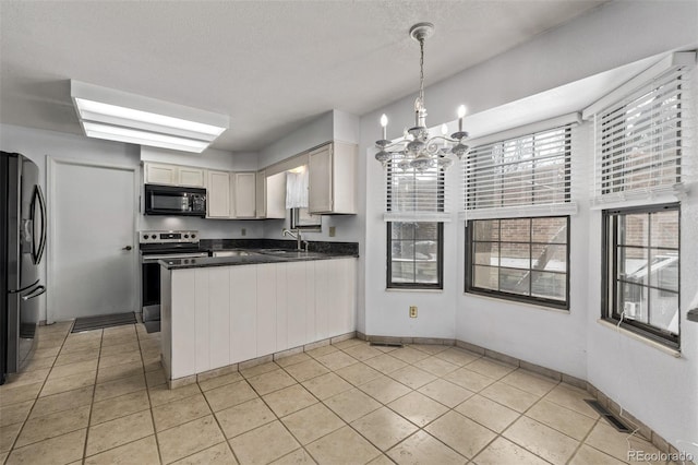 kitchen featuring appliances with stainless steel finishes, sink, a notable chandelier, white cabinets, and hanging light fixtures