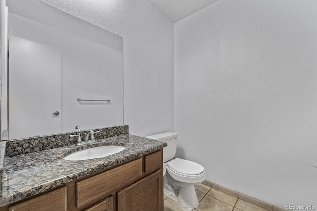 bathroom featuring tile patterned floors, toilet, and vanity