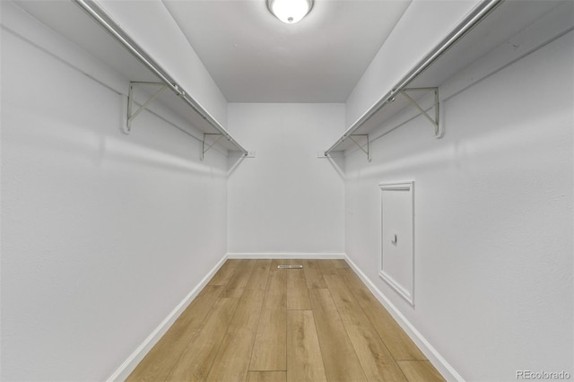 spacious closet with light hardwood / wood-style floors