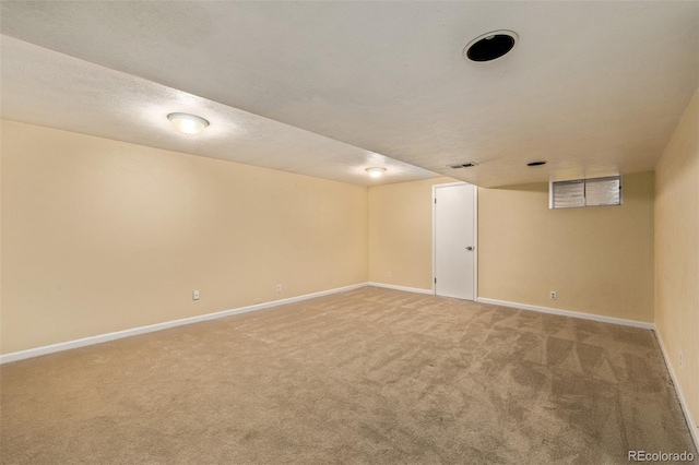 basement with carpet and a textured ceiling