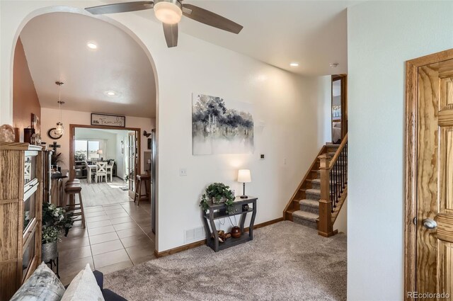 1141 Beech St, Fort Lupton, CO 80621 - tiled living room with arched walkways, a ceiling fan, stairs, baseboards, and recessed lighting