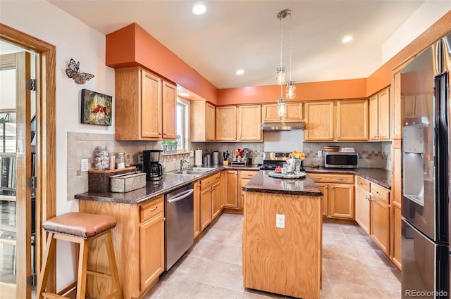1141 Beech St, Fort Lupton, CO 80621 - kitchen with appliances with stainless steel finishes, a kitchen island, decorative backsplash, under cabinet range hood, and a sink