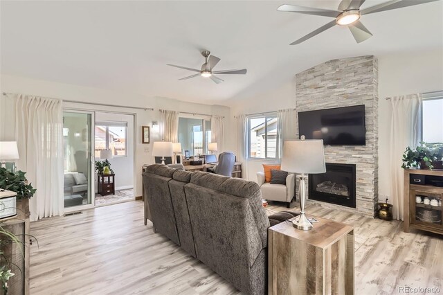 1141 Beech St, Fort Lupton, CO 80621 - living room featuring ceiling fan, light wood-style flooring, vaulted ceiling, and a fireplace