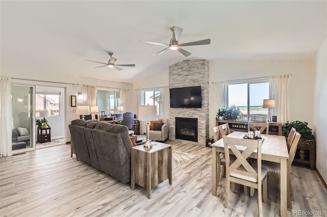 1141 Beech St, Fort Lupton, CO 80621 - living room featuring a stone fireplace, light wood finished floors, a ceiling fan, and lofted ceiling