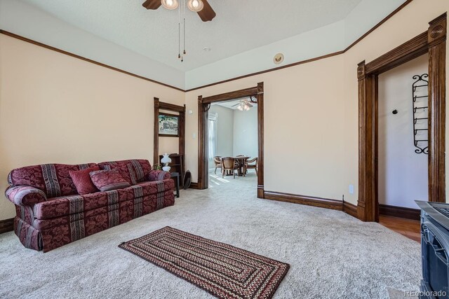 carpeted living room featuring a textured ceiling and ceiling fan