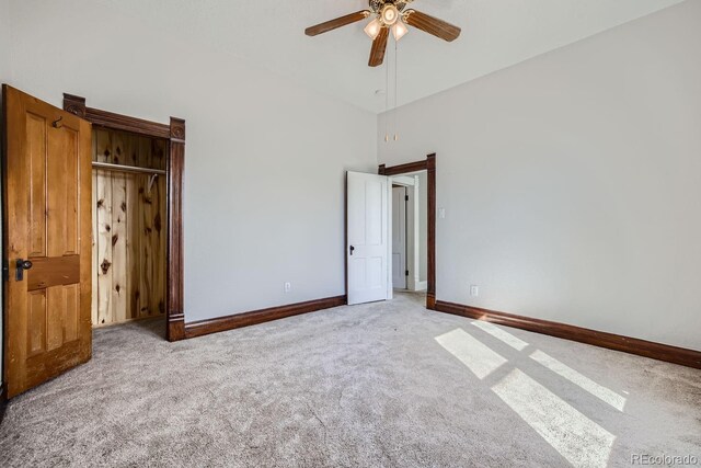 unfurnished bedroom with high vaulted ceiling, ceiling fan, and carpet flooring