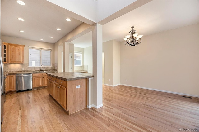 kitchen featuring dishwasher, pendant lighting, backsplash, and light hardwood / wood-style floors