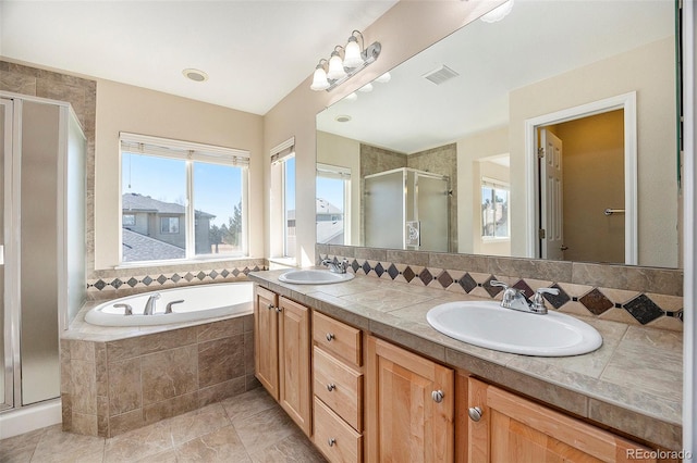 bathroom with vanity, shower with separate bathtub, and backsplash