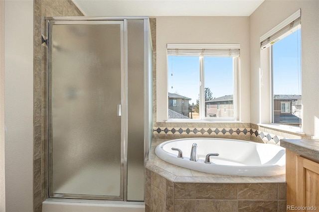 bathroom featuring independent shower and bath and vanity