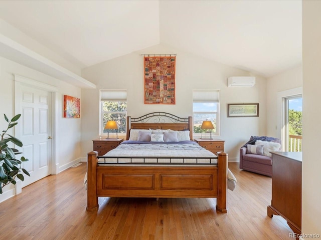 bedroom featuring a wall unit AC, high vaulted ceiling, and light hardwood / wood-style floors