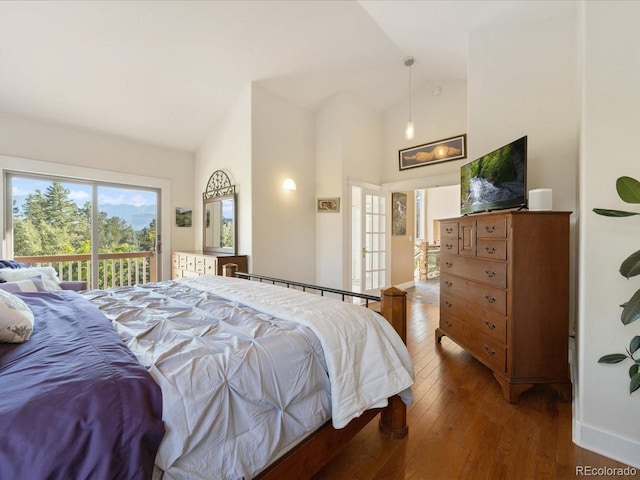 bedroom featuring dark wood-type flooring, high vaulted ceiling, and access to outside