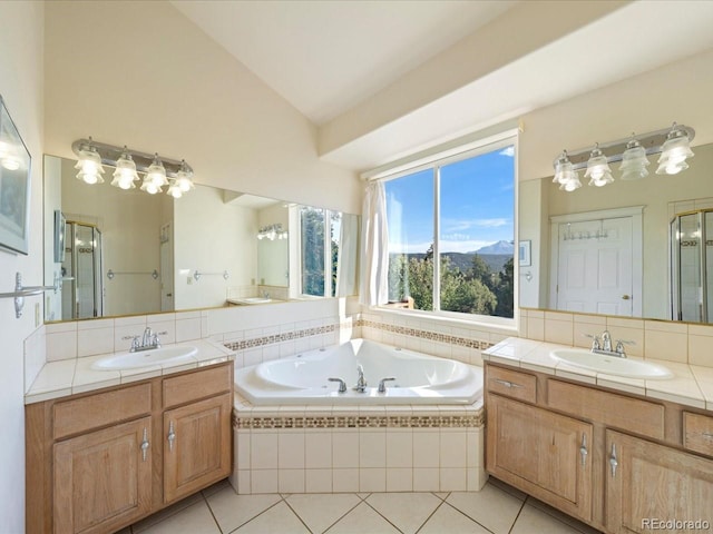 bathroom featuring vanity, lofted ceiling, tile patterned floors, and shower with separate bathtub