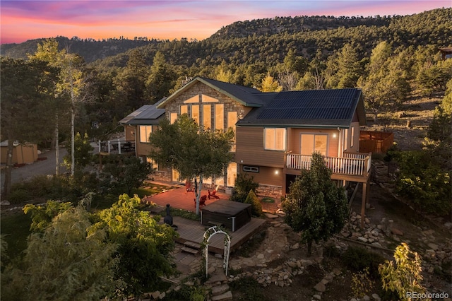 back house at dusk with a deck