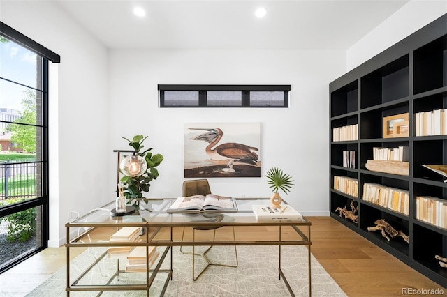 office space with plenty of natural light, wood finished floors, and recessed lighting