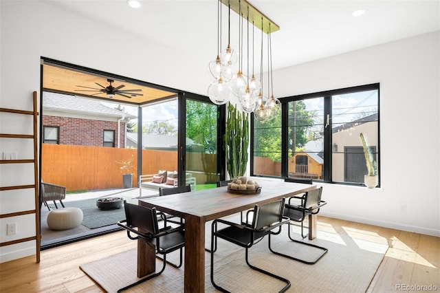 dining room with wood finished floors, baseboards, recessed lighting, and a chandelier