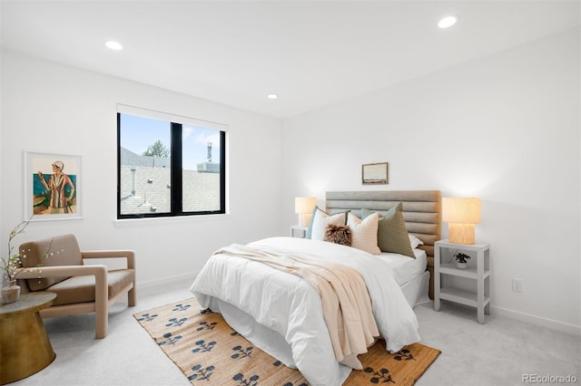 bedroom with light carpet, recessed lighting, and baseboards