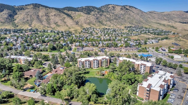 drone / aerial view featuring a water and mountain view