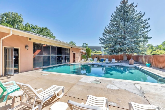 view of swimming pool with a fenced in pool, a fenced backyard, and a patio