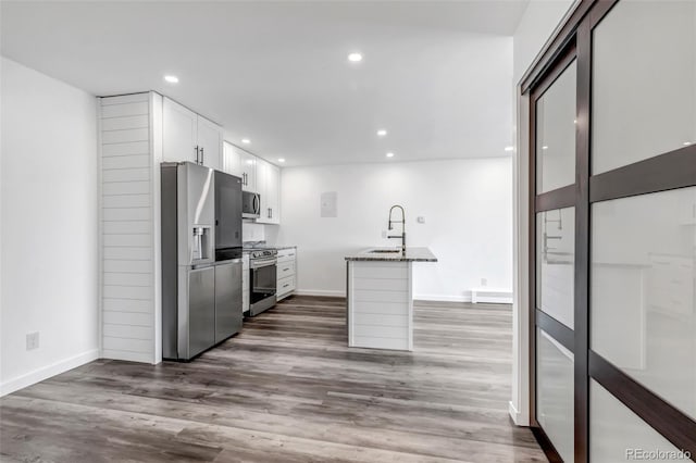 kitchen with recessed lighting, dark wood-style flooring, a sink, white cabinetry, and appliances with stainless steel finishes