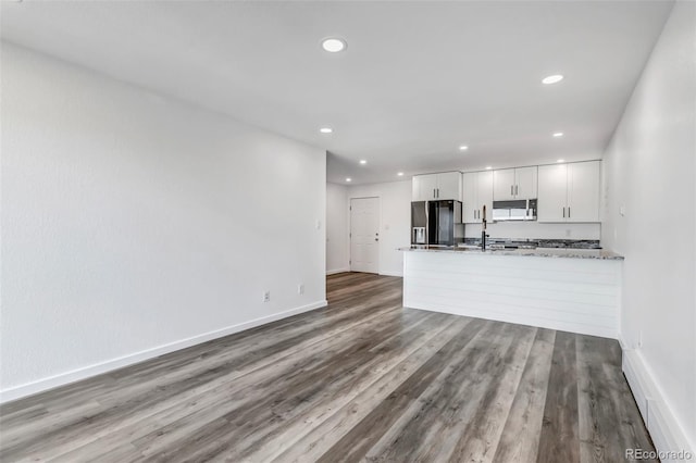 interior space with recessed lighting, baseboards, and wood finished floors