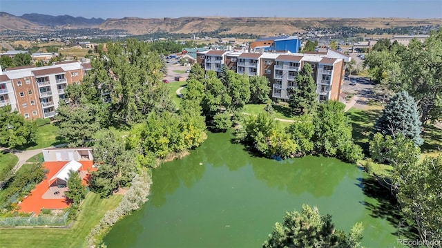 drone / aerial view featuring a water and mountain view