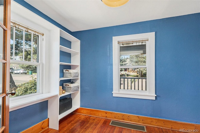 4196 S Pennsylvania St, Englewood, CO 80113 - unfurnished room with baseboards, visible vents, a healthy amount of sunlight, and hardwood / wood-style flooring