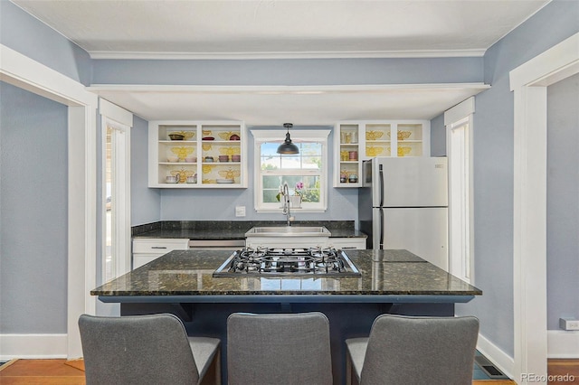 4196 S Pennsylvania St, Englewood, CO 80113 - kitchen featuring open shelves, a sink, freestanding refrigerator, stainless steel gas stovetop, and a kitchen bar