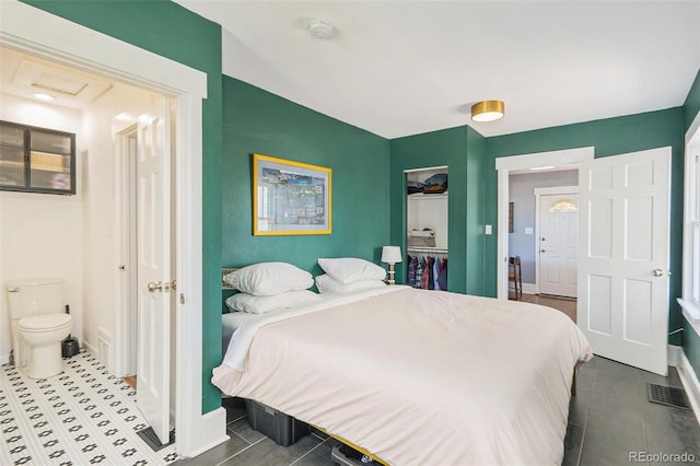 4196 S Pennsylvania St, Englewood, CO 80113 - bedroom featuring connected bathroom, dark tile patterned floors, baseboards, and visible vents