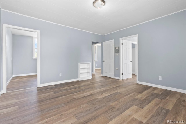 10911 W 44th Pl, Wheat Ridge, CO 80033 - spare room featuring crown molding, baseboards, and wood finished floors
