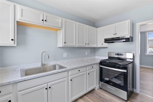10911 W 44th Pl, Wheat Ridge, CO 80033 - kitchen featuring under cabinet range hood, stainless steel range with gas stovetop, a sink, and light wood-style floors