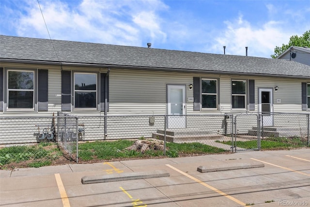 10911 W 44th Pl, Wheat Ridge, CO 80033 - view of front of home with a fenced front yard, uncovered parking, and roof with shingles