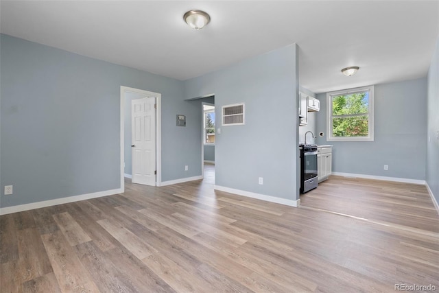 10911 W 44th Pl, Wheat Ridge, CO 80033 - unfurnished living room featuring light wood finished floors and baseboards