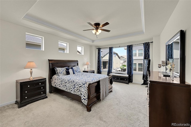 6335 E 143rd Dr, Thornton, CO 80602 - bedroom with a tray ceiling, light carpet, multiple windows, and ceiling fan