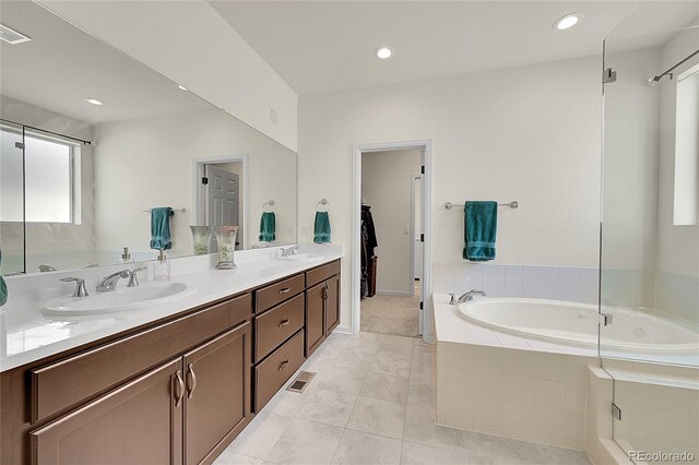 6335 E 143rd Dr, Thornton, CO 80602 - bathroom featuring a bath, double vanity, tile patterned flooring, a walk in closet, and recessed lighting