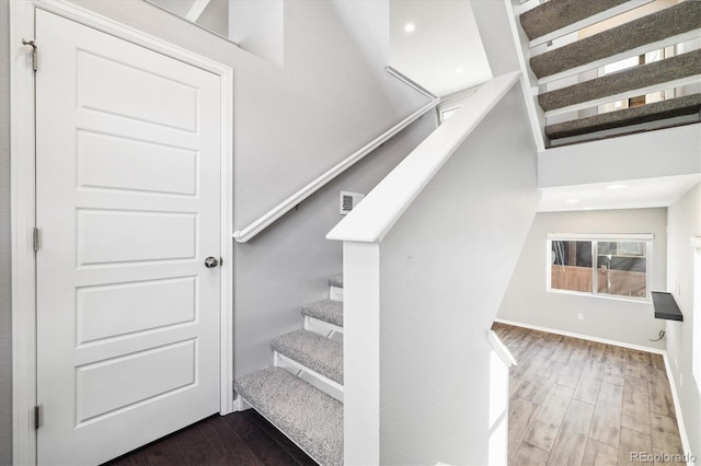 stairway with hardwood / wood-style flooring