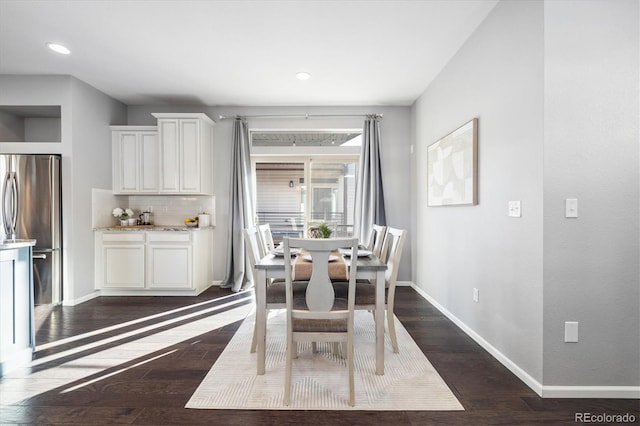 dining space featuring dark wood-type flooring