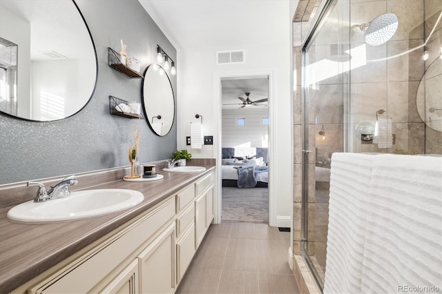 bathroom with vanity, a shower with shower door, and ceiling fan