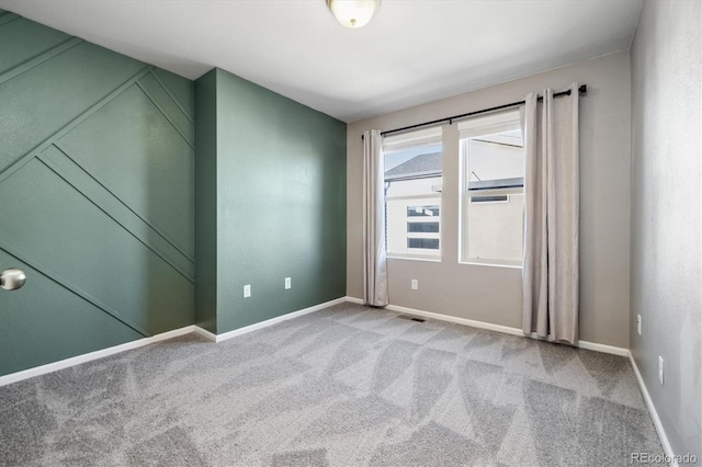 spare room featuring light colored carpet