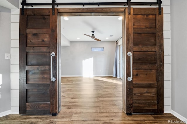 interior space featuring hardwood / wood-style flooring and a barn door