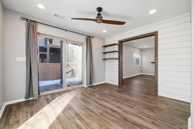 unfurnished room with ceiling fan and dark hardwood / wood-style flooring