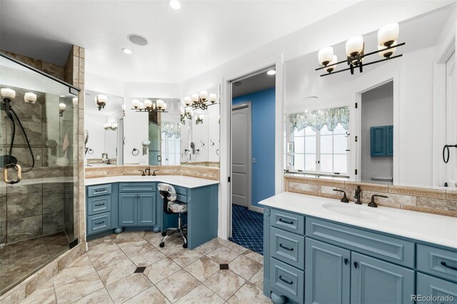 9151 E Harvard Ave, Denver, CO 80231 - bathroom with a chandelier, two vanities, a stall shower, and recessed lighting