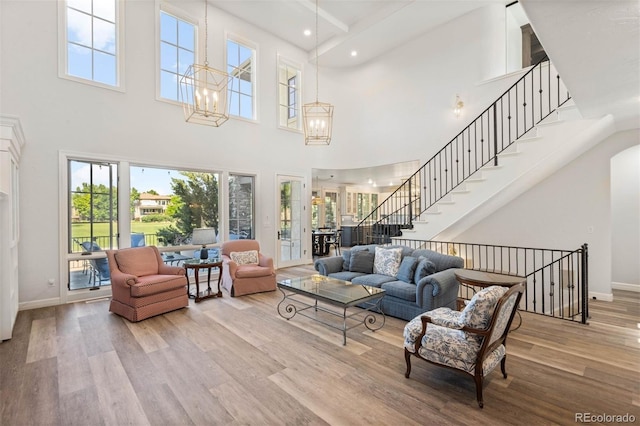 9151 E Harvard Ave, Denver, CO 80231 - living room featuring a high ceiling, wood finished floors, a chandelier, recessed lighting, and stairway