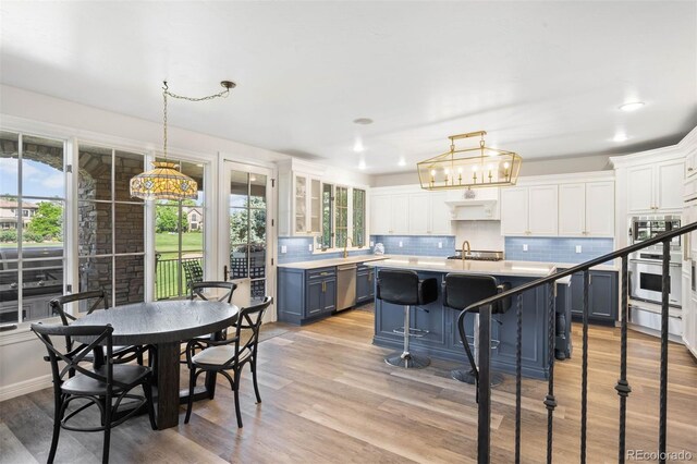 9151 E Harvard Ave, Denver, CO 80231 - dining area with light wood-type flooring and recessed lighting