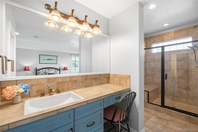 9151 E Harvard Ave, Denver, CO 80231 - bathroom with decorative backsplash, vanity, a stall shower, and recessed lighting