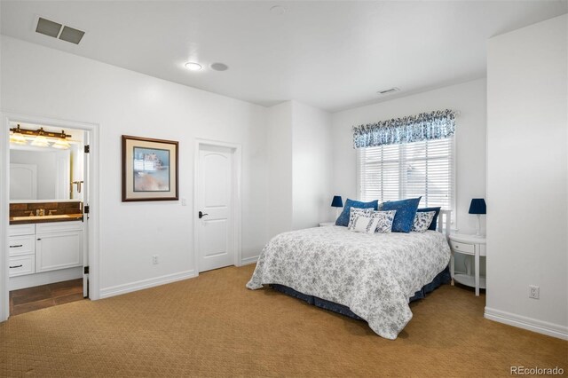 9151 E Harvard Ave, Denver, CO 80231 - carpeted bedroom with a sink and ensuite bath