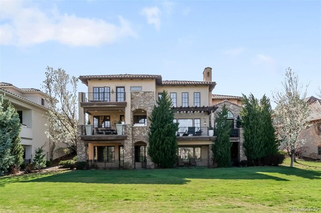 9151 E Harvard Ave, Denver, CO 80231 - back of property with a balcony, a chimney, and a lawn