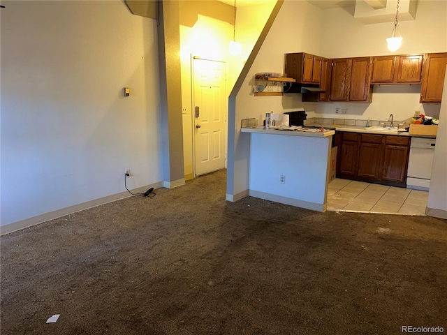 kitchen featuring a high ceiling, light colored carpet, white dishwasher, and a sink